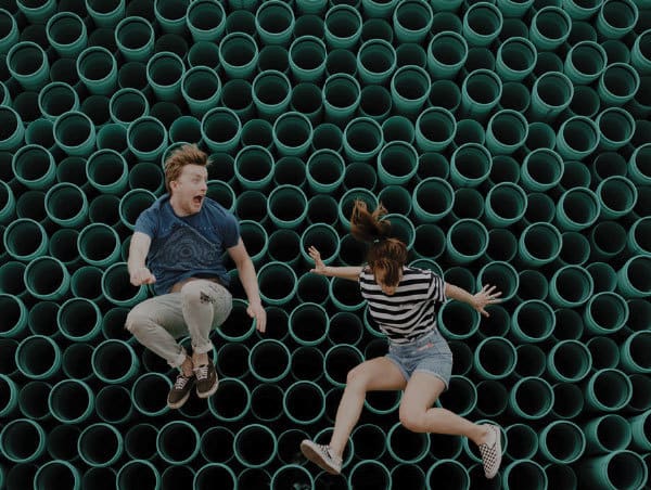 Teens jumping in front of wall